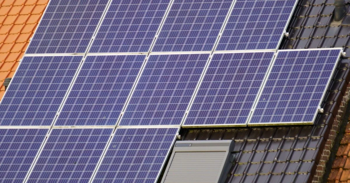 Vue rapprochée de panneaux solaires sur un toit en tuiles, capturant de l'énergie propre.